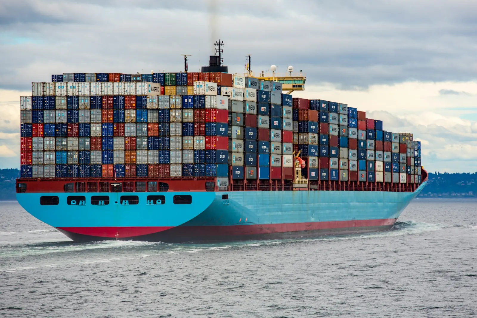 Container ship underway, loaded above the deck line